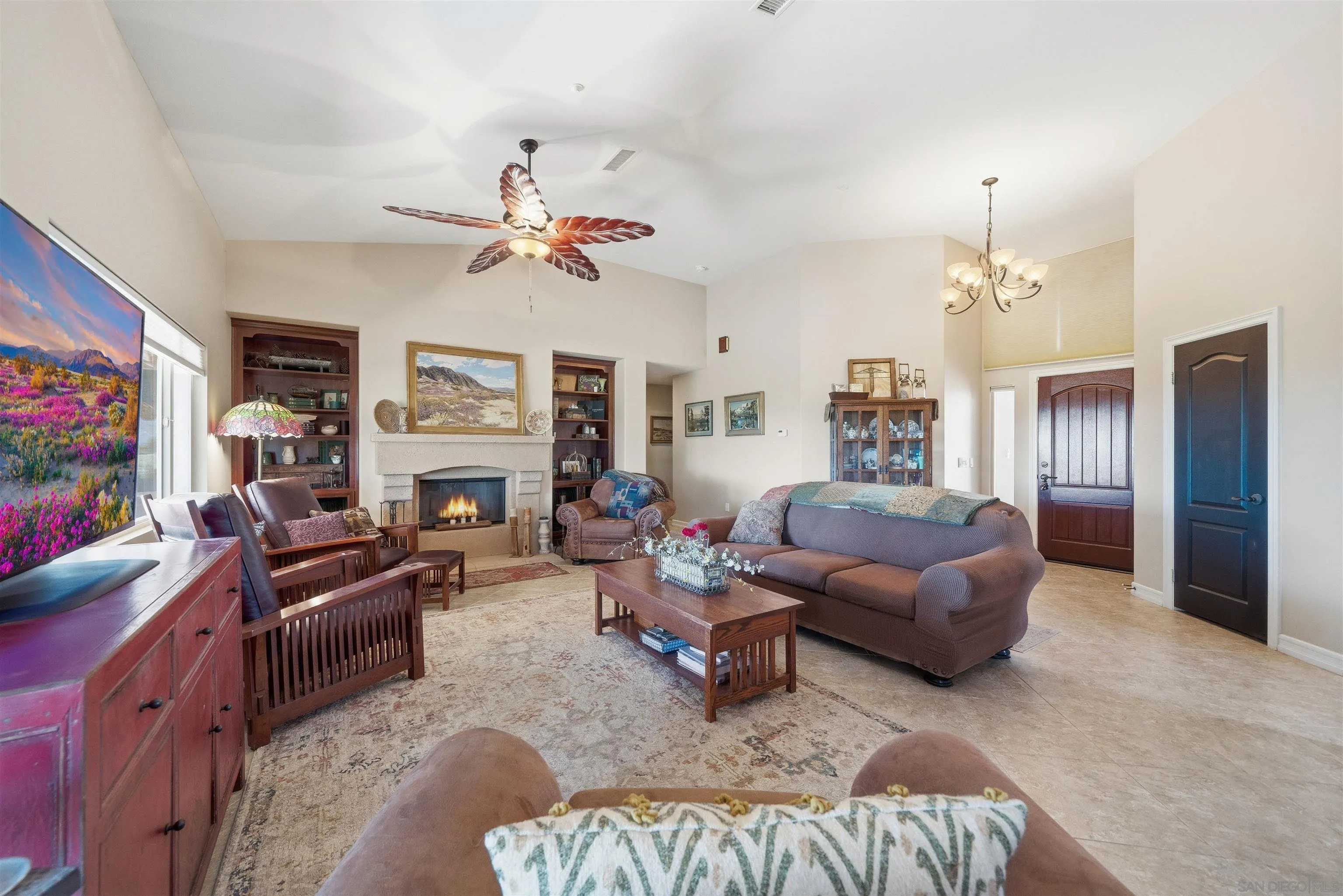 3277 Frying Pan Road Borrego Springs, CA 92004 - Photo 13 of 43 a living room with furniture a fireplace and a chandelier