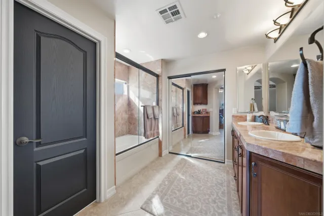 a bathroom with a sink a mirror and a shower