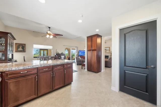 a kitchen with stainless steel appliances granite countertop a refrigerator and a sink