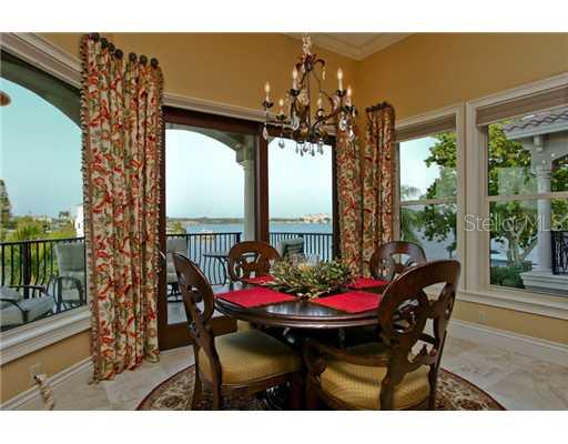 Dining Room - This majestic dining area delivers 180 degree views and access to a gorgeous wrap-around deck with a built-in luxury grill - perfect for entertaining and enjoying nightlife on the waterfront.