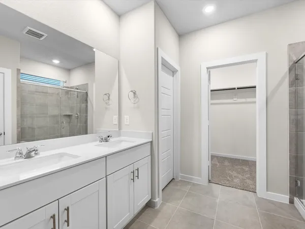 a bathroom with a shower sink and mirror
