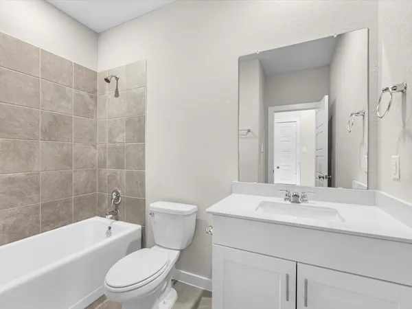 a bathroom with a sink a toilet a mirror a bathtub and shower