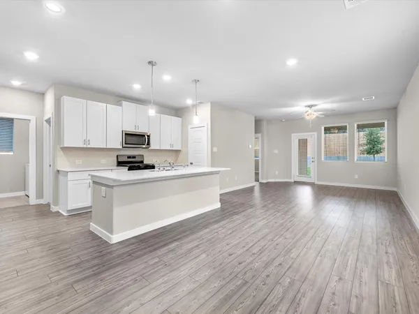 a view of kitchen with sink and wooden floor