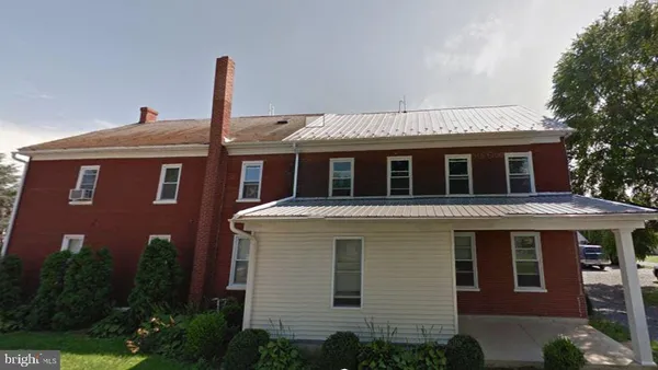 a front view of a house with plants