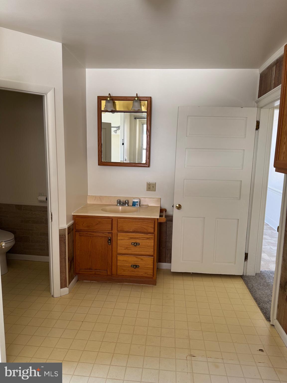 404 Linden Grove Road Ephrata, PA 17522 - Photo 11 of 16 a bathroom with a granite countertop sink a toilet and a mirror