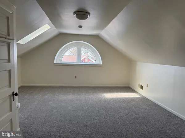 a view of a brick house with wooden fence