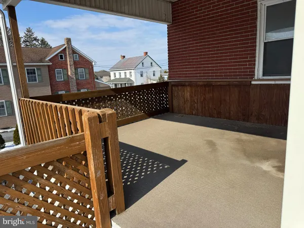 a view of a balcony with wooden floor
