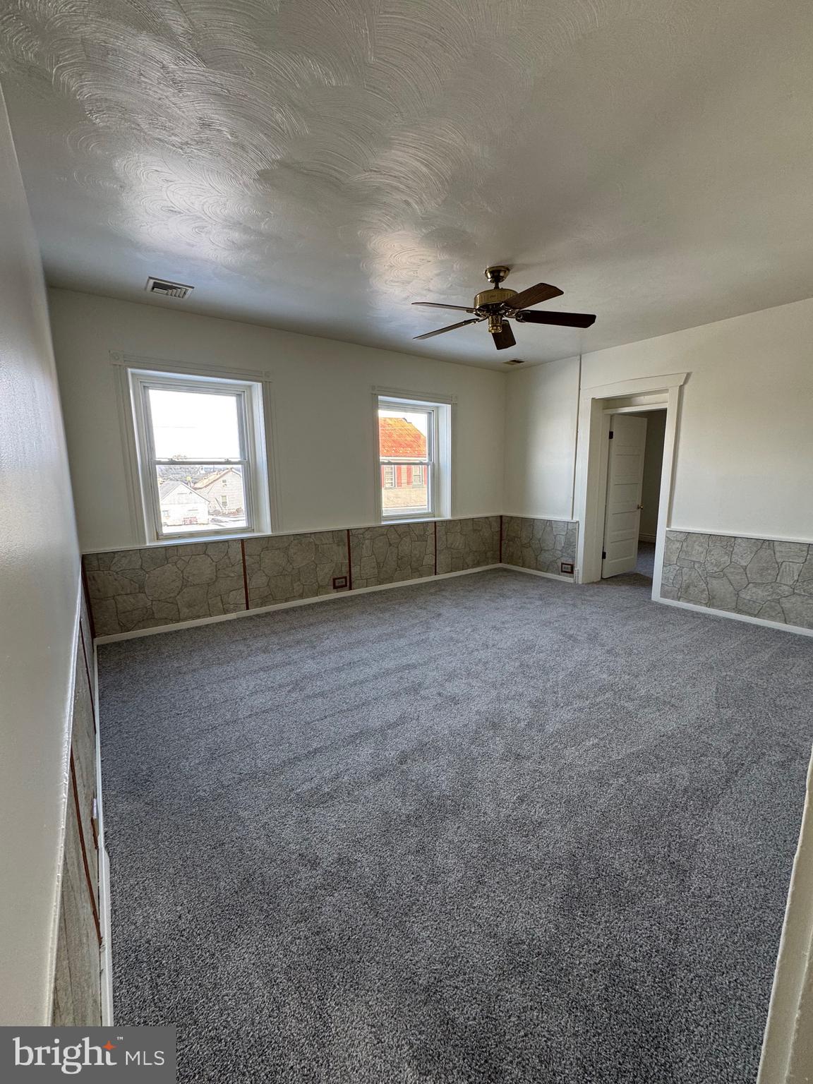 404 Linden Grove Road Ephrata, PA 17522 - Photo 7 of 16 an empty room with windows and ceiling fan