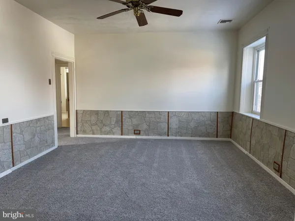 a bathroom with a granite countertop sink a toilet and a mirror