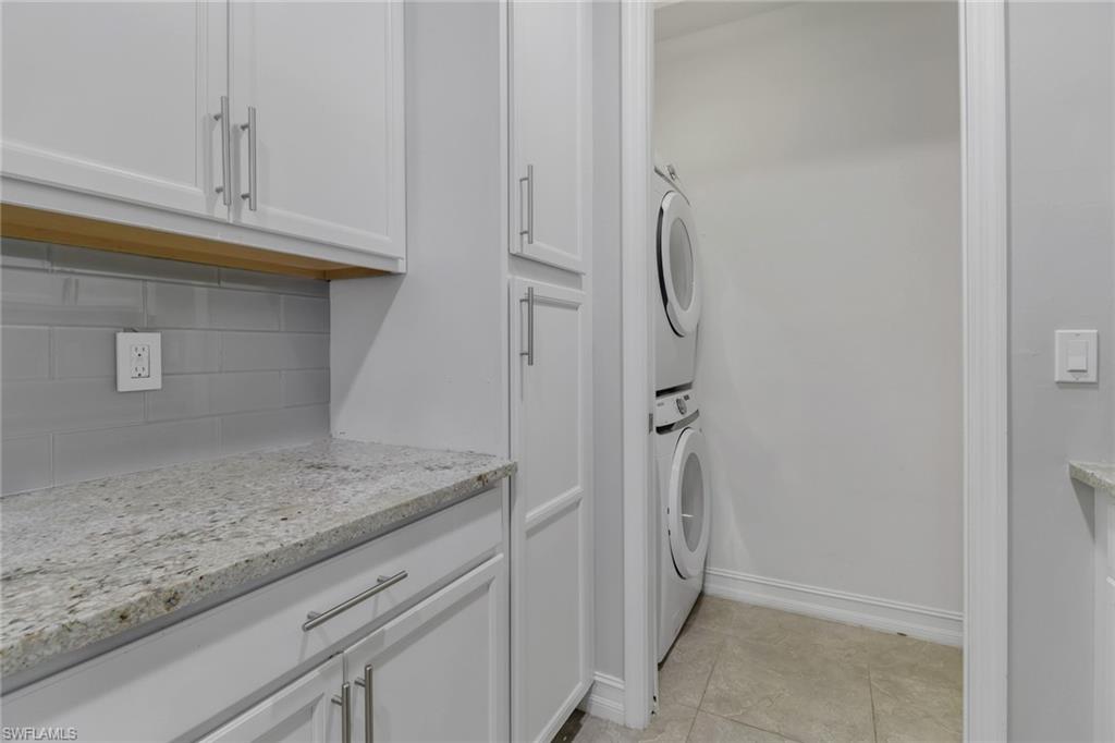 7948 Bristol Circle Naples, FL 34120 - Photo 7 of 27 a view of bathroom with granite countertop cabinets
