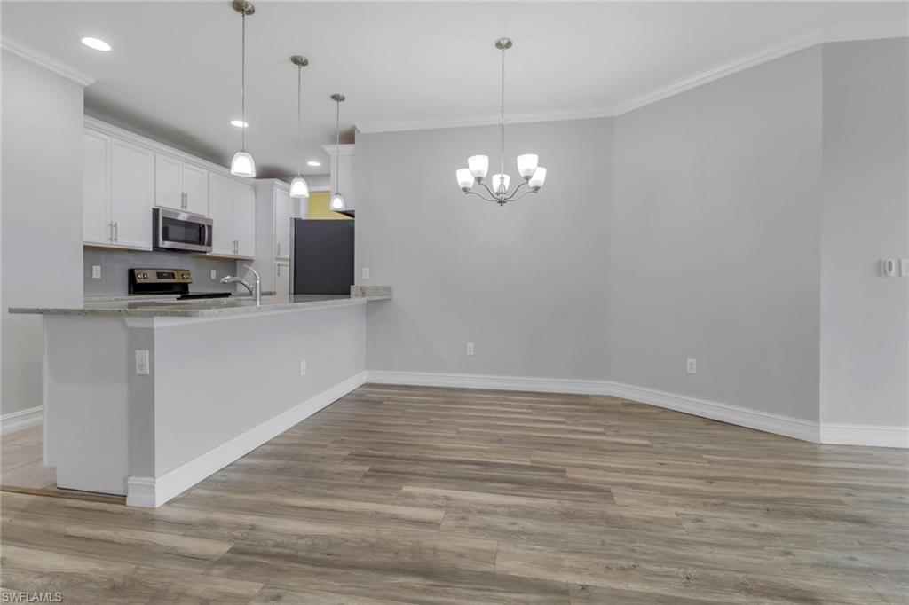 7948 Bristol Circle Naples, FL 34120 - Photo 8 of 27 a view of a kitchen with a sink and chandelier