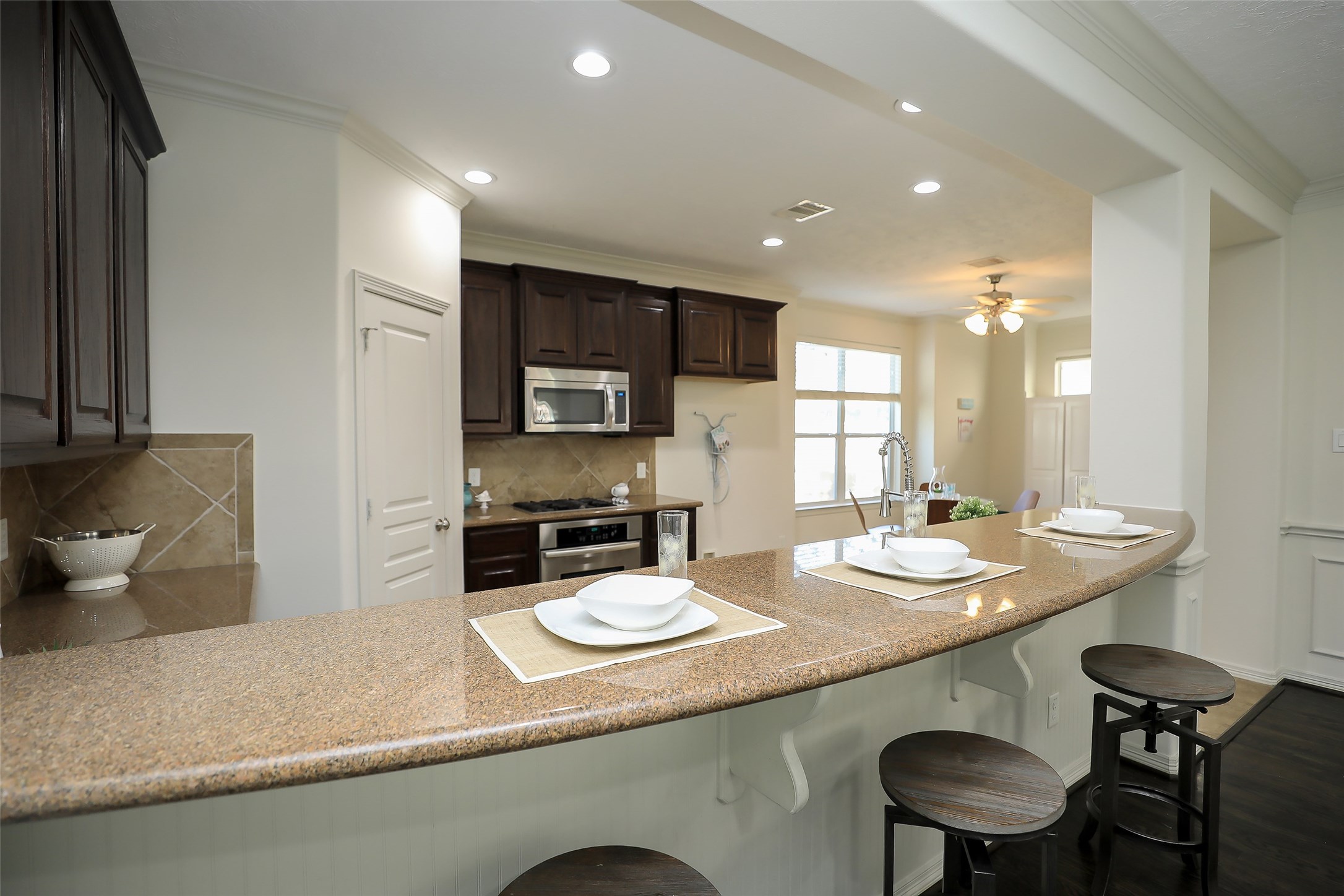 1311 Bingham Street, Unit B Houston, TX 77007 - Photo 13 of 29 a kitchen with sink and chairs