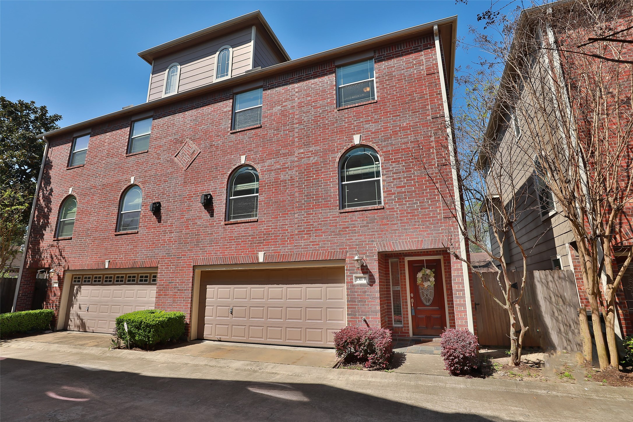 1311 Bingham Street, Unit B Houston, TX 77007 - Photo 2 of 29 a front view of a house with a yard
