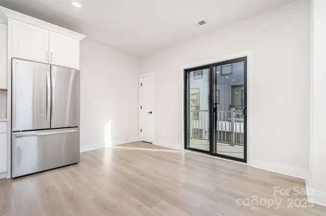 a view of a kitchen with a refrigerator and a sink