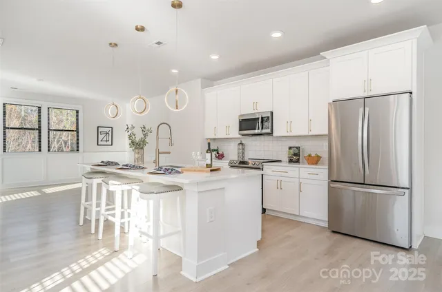 a kitchen with cabinets and stainless steel appliances