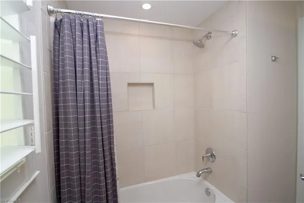 a bathroom with a bathtub and shower