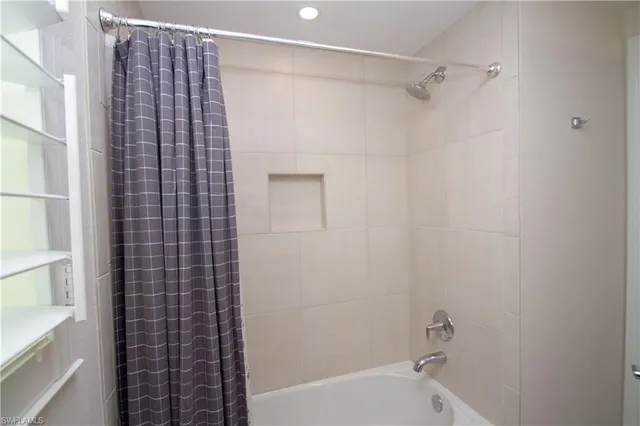 a bathroom with a bathtub and shower