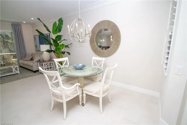 a dining room with furniture potted plants and wooden floor