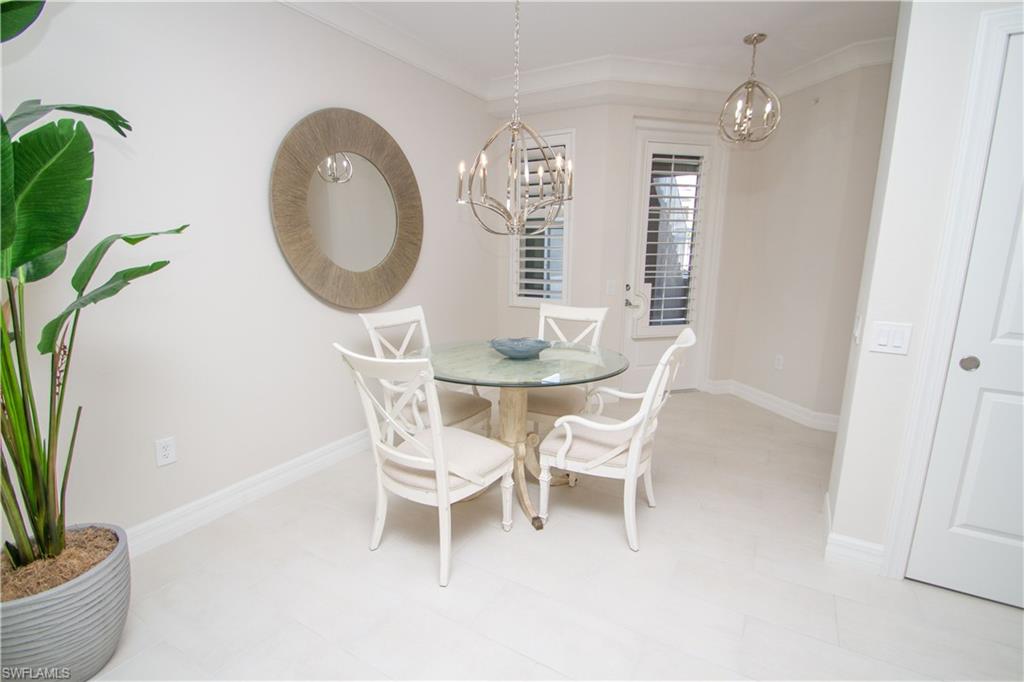 232 Indies Drive East, Unit 101 Naples, FL 34114 - Photo 19 of 50 a dining room with furniture and a potted plant