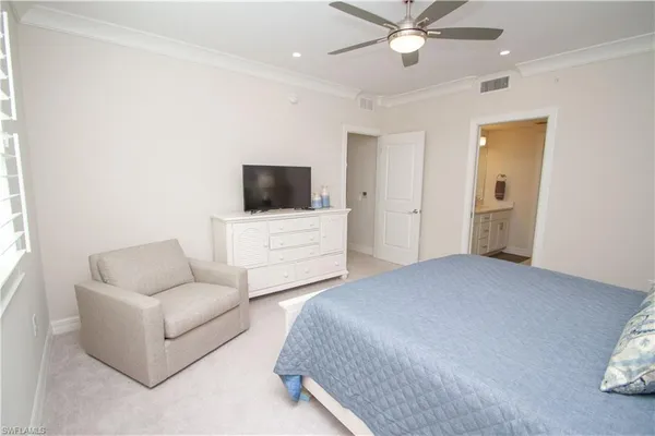 a bedroom with a bed couch and window
