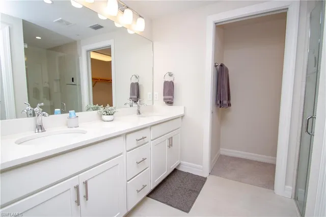 a bathroom with a double vanity sink and a mirror