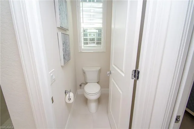 a white toilet sitting next to a window