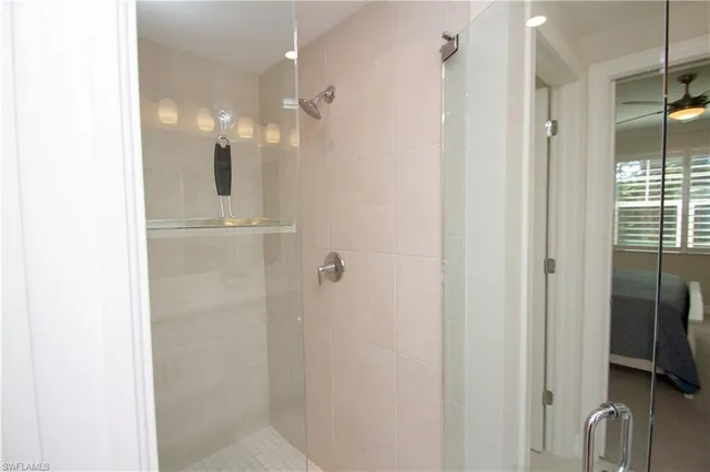 a bathroom with a shower and a glass door