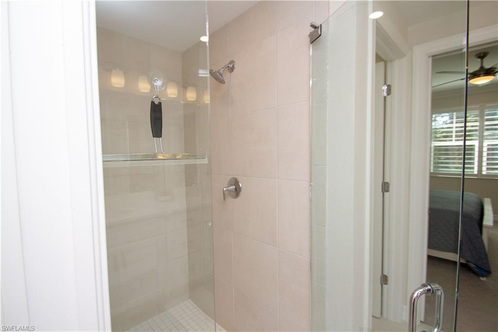 232 Indies Drive East, Unit 101 Naples, FL 34114 - Photo 26 of 50 a bathroom with a shower and a glass door