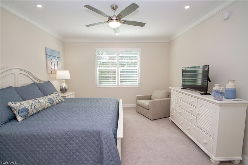 232 Indies Drive East, Unit 101 Naples, FL 34114 - Photo 28 of 50 a bed room with furniture and a window