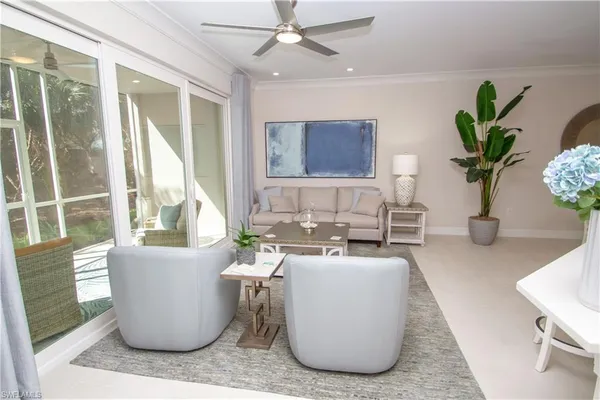 a living room with furniture and a potted plant