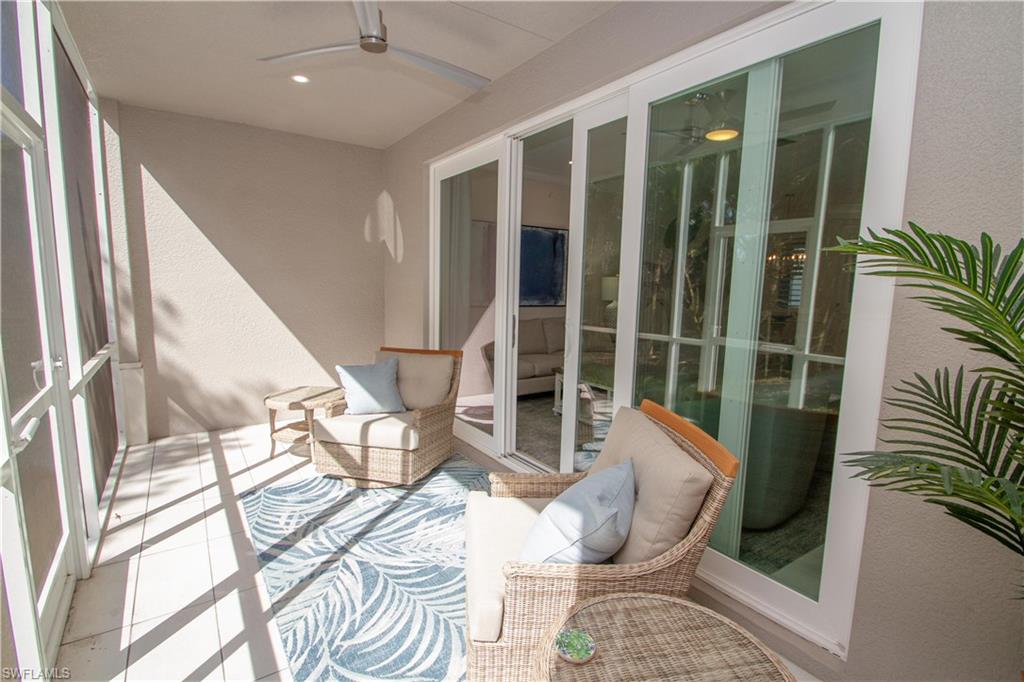 232 Indies Drive East, Unit 101 Naples, FL 34114 - Photo 35 of 50 a living room with furniture and a large window