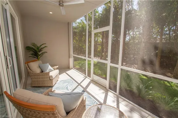 a balcony with furniture and potted plants