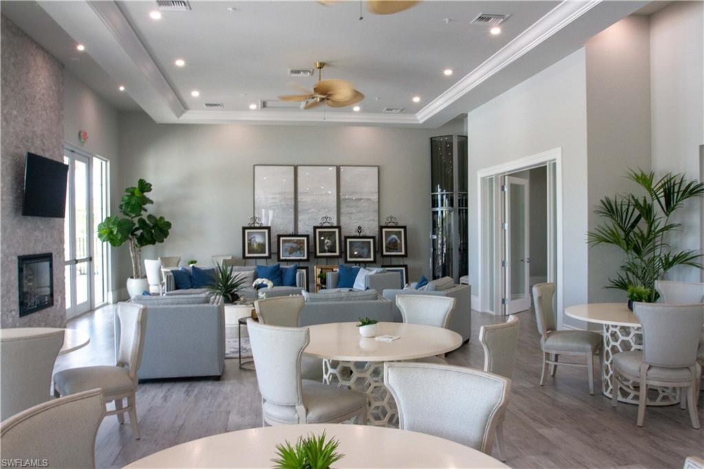 232 Indies Drive East, Unit 101 Naples, FL 34114 - Photo 39 of 50 a living room with furniture and a large window