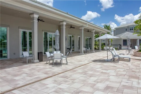 a building outdoor space with glass windows and outdoor seating