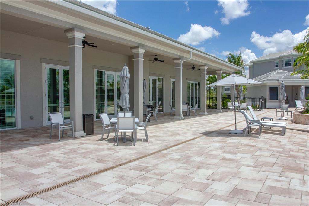232 Indies Drive East, Unit 101 Naples, FL 34114 - Photo 45 of 50 a building outdoor space with glass windows and outdoor seating