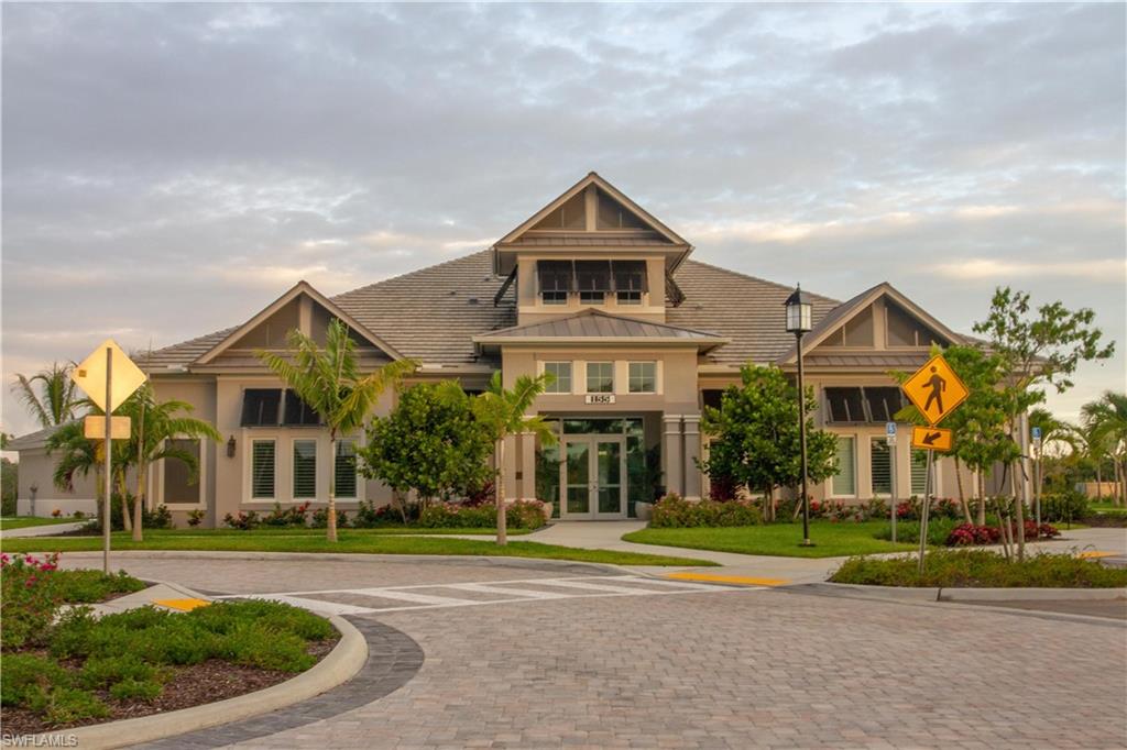 232 Indies Drive East, Unit 101 Naples, FL 34114 - Photo 50 of 50 a front view of a house with a yard and garage
