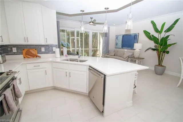 a kitchen with a sink and white cabinets