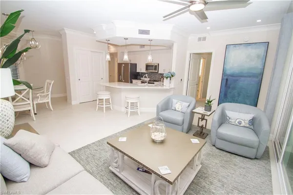 a living room with furniture and a dining table