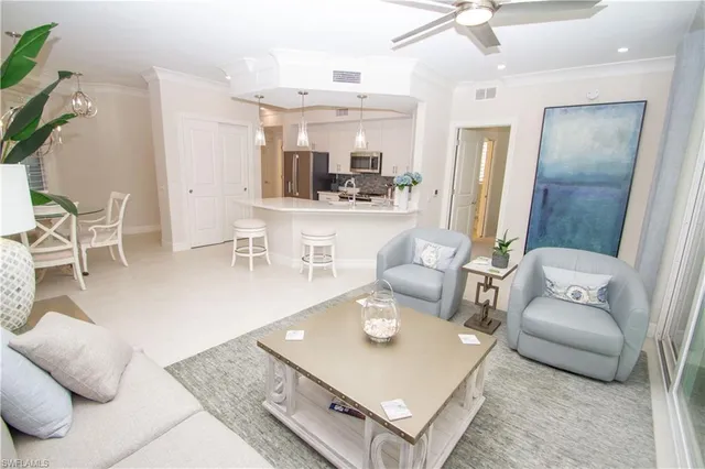 a living room with furniture and a dining table