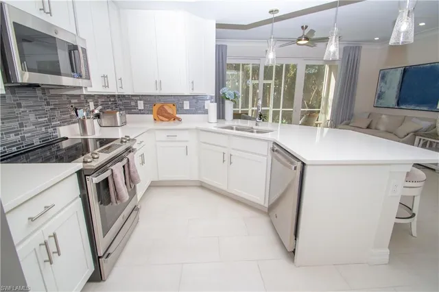 a kitchen that has a sink and a stove in it