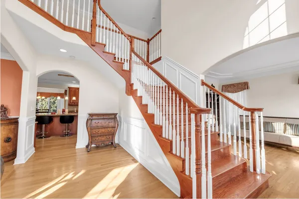a view of entryway and hall with wooden floor