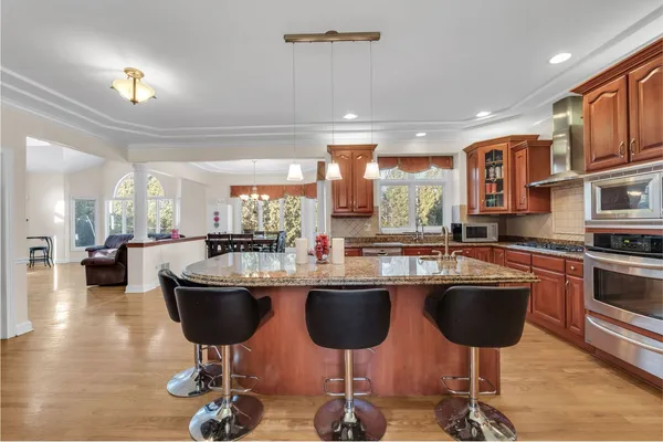 a kitchen with stainless steel appliances kitchen island granite countertop a sink and cabinets