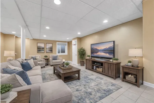 a living room with furniture and a flat screen tv