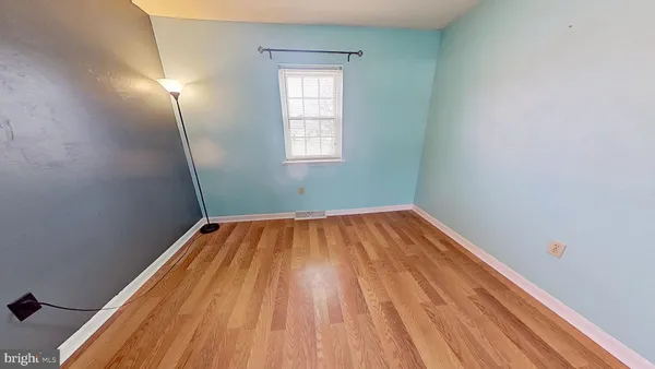 a view of a room with wooden floor and natural light