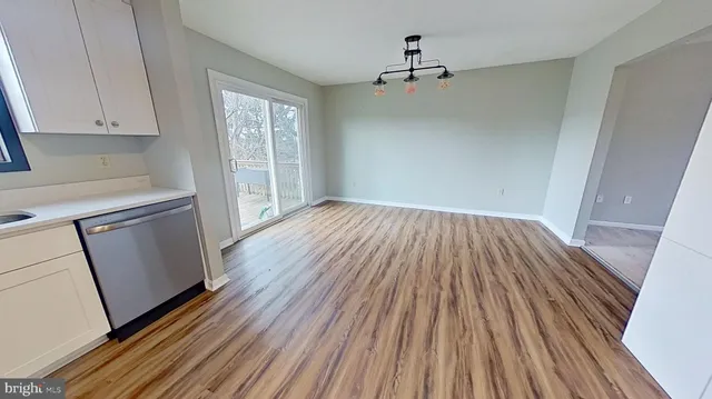a view of a hardwood floor in a kitchen