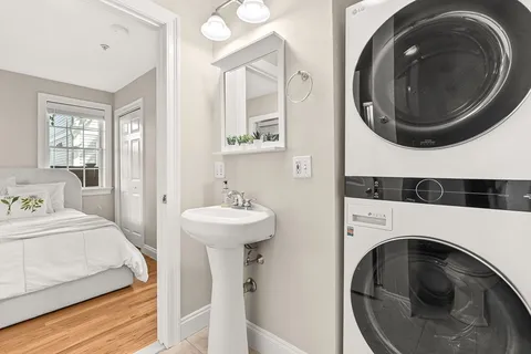 a en suite bathroom with a sink and a washer