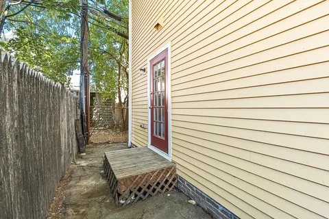 a view of a wooden bench sitting in front of house