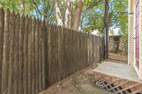 a bedroom with a bed and a wooden fence