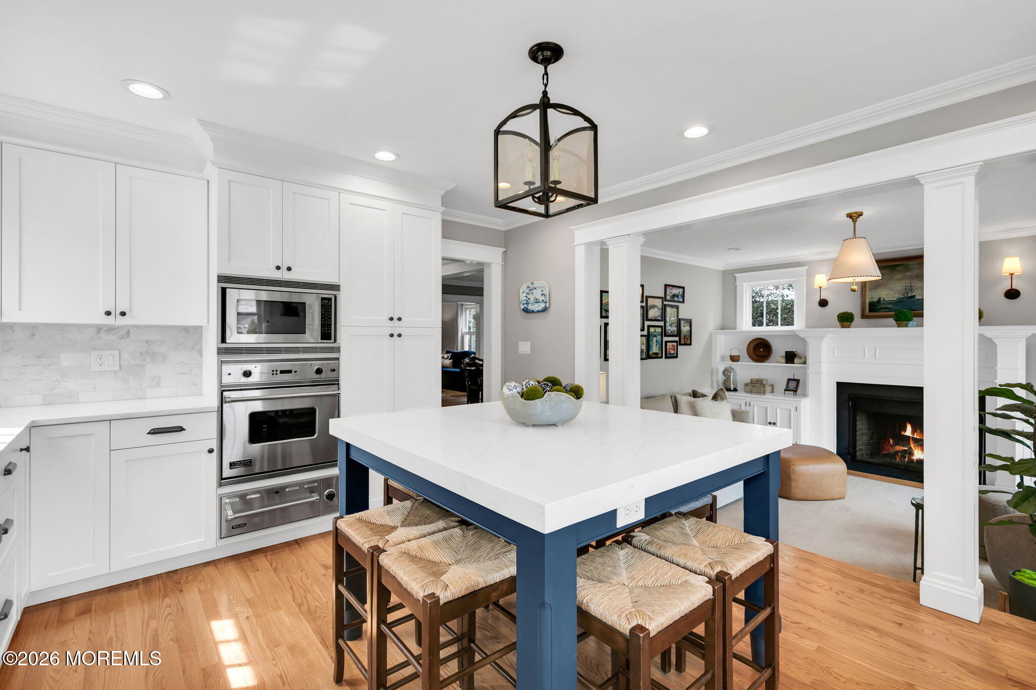 43 Bingham Avenue Rumson, NJ 07760 - Photo 19 of 59 a kitchen with stainless steel appliances granite countertop a stove a refrigerator a kitchen island a dining table and chairs with wooden floor
