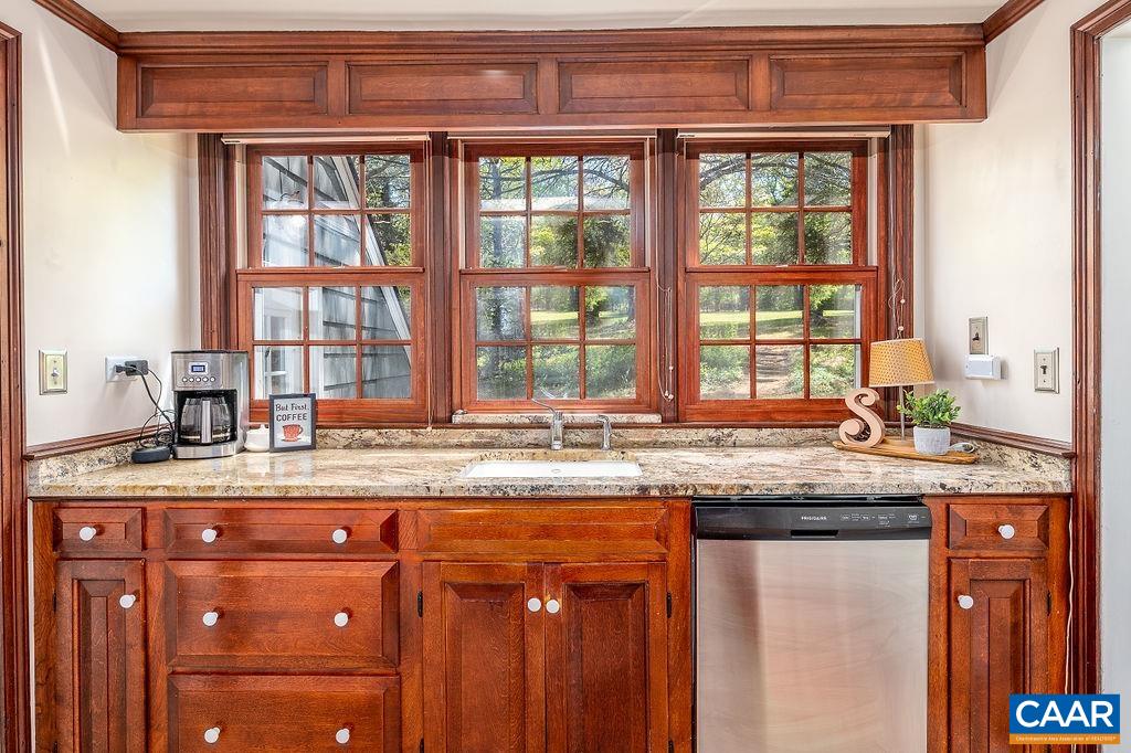 19 Old Farm Road Charlottesville, VA 22903 - Photo 12 of 29 a kitchen with kitchen island granite countertop a stove a sink and a wooden cabinets